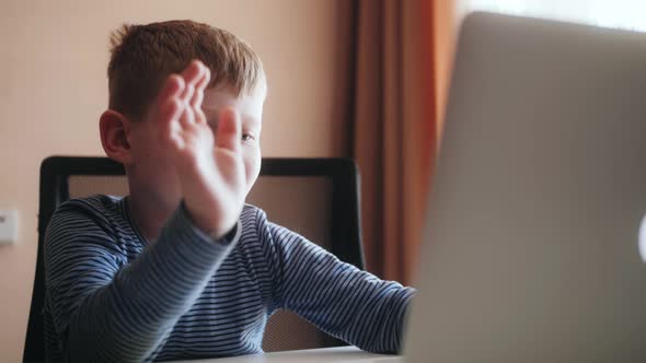 Funny Kid Boy Waving Talking to Distance Teacher During Online Virtual Chat Video Call Meeting By