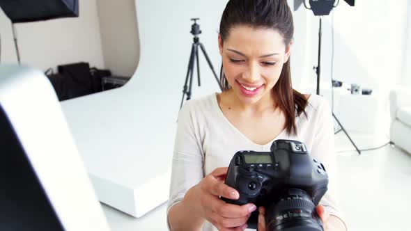 Photographer looking at photos on digital camera