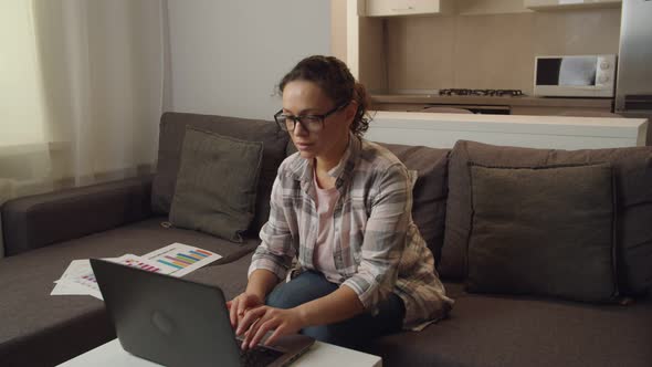 Moving Shot of Adult Female Freelancer in Eyeglasses Working at Home