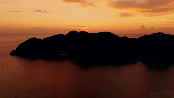 Amazing colorful sunset behind an island. Ko Phi Phi Thailand at dusk. Aerial