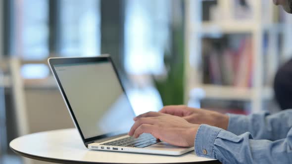 Close Up of African Man Working on Laptop