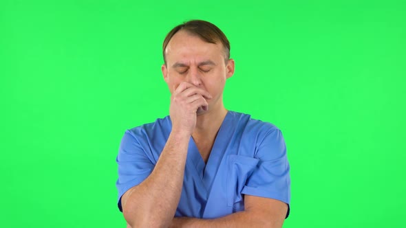 Medical Man Listens Carefully To Boring Information. Green Screen