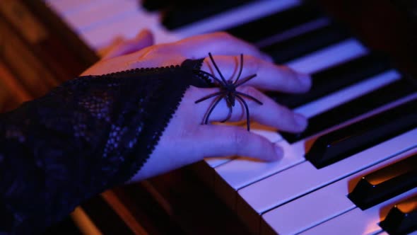 Woman Playing on Vintage Wooden Piano at Halloween