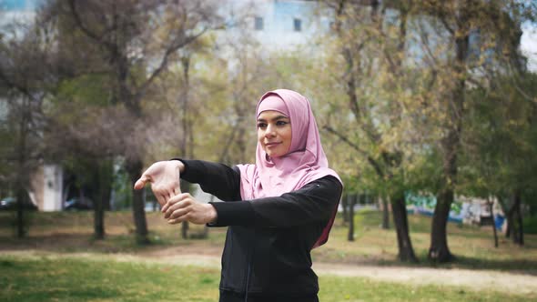 Young Fitness Muslim Woman Runner Warming Up and Stretching Before Run