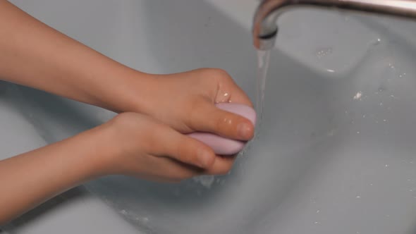 Hand Care. Wash Your Hands Under Running Water. The Child Washes His Hands with Soap. Boy Washes His