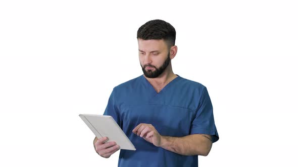 Confident Concentrated Focused Surgeon Using Digital Tablet on White Background