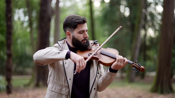 Charismatic Violinist is Playing Old Fiddle in Forest in Daytime Medium Portrait