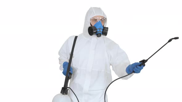 Man in a Hazmat Walking in and Using Disinfectant on White Background