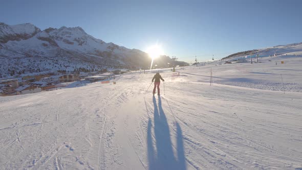 Woman beginner skier at ski resort in the mountains