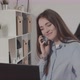 Girl Talking on the Phone with a Laptop - VideoHive Item for Sale
