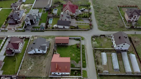 aerial view of houses on housing estates, some with building on roof panels