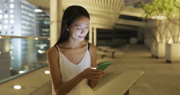 Woman using mobile phone at street 