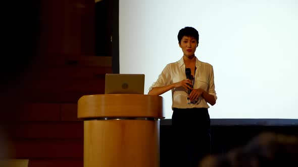 Young Asian businesswoman speaking in business seminar in auditorium 4k