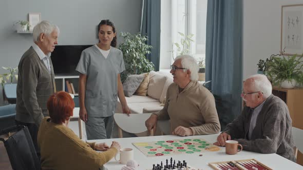 Nurse Introducing Senior Man to People in Nursing Home