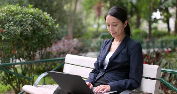 Asian Businesswoman work on notebook computer in city of Hong Kong