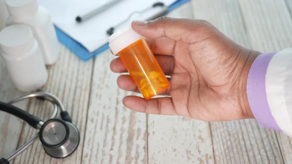 Doctor Hand Holding Pill Container with Copy Space