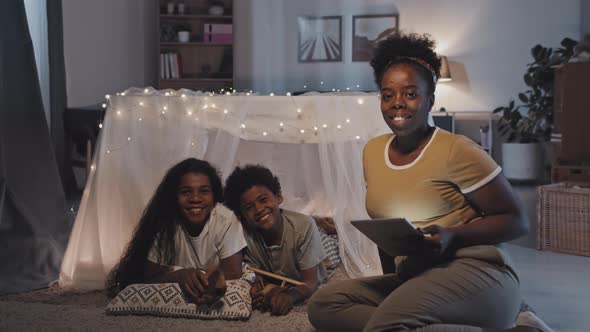 Woman and Kids in Blanket Fort Posing