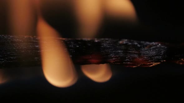 Burning Match on Black Background in Macro