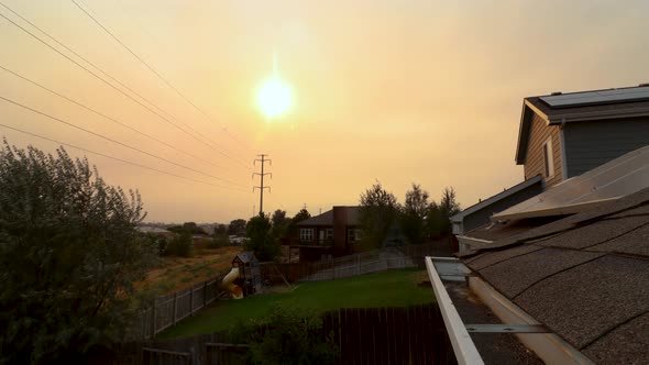 The sun sets in a sky filled with smoke and ashes during the 2020 forest fires in Colorado during Ju
