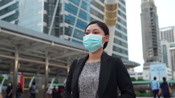 business woman walking and wearing medical mask for protection from coronavirus