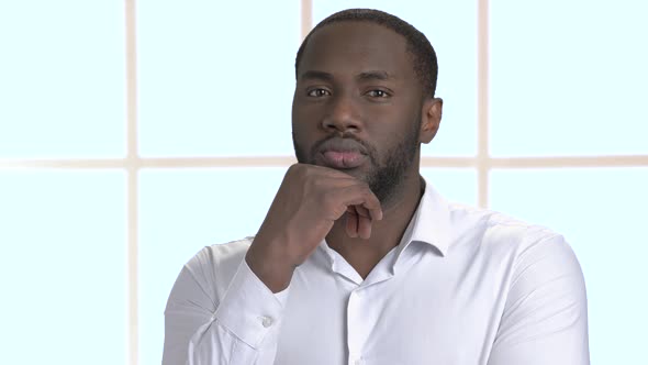 Confused Afro-american Businessman in White Shirt.