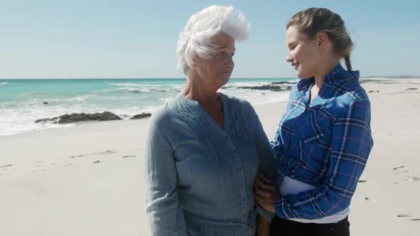 Woman and her mother enjoying free time on the beach together