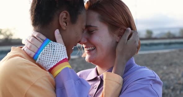 Happy lesbian couple having tender moment outdoor