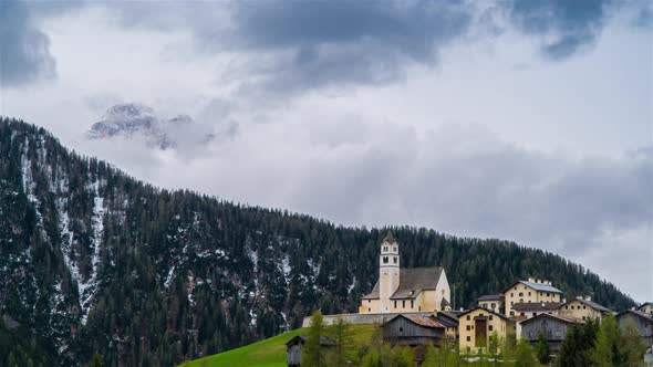 Clouds Move Over the Mountain Valley and Alpine Village