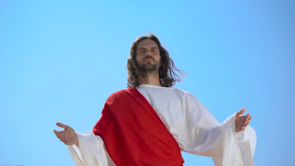 Saint Man in Robe Raising Hands to Sky, Praying for Soul Salvation, Resurrection