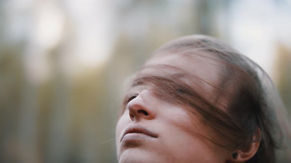 Young Brunette Rising Up Her Head While Long Hair Stays on Her Face. Close Up Slow Motion Shot