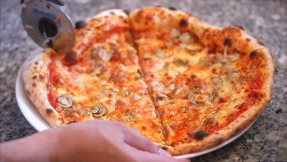 Freshly Pizza of Slicing a Pepperoni Pizza Into Multiple Slices With a Pizza Cutter