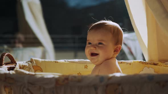 Baby to Sit in Crib in the Evening Face of Happy Baby in Light of Night Lamp