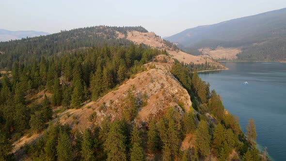 Flyover of rattlesnake point at Kalamalka lake during sunset. Lots of smoke in the air due to BC wil