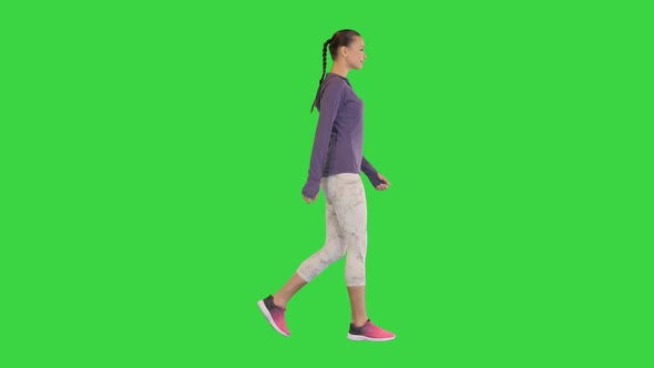 Cute Fitness Woman Having a Walk on a Green Screen Chroma Key