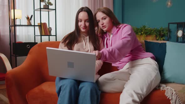 Happy Two Female Women Couple Family on Sofa at Home Enjoy Chatting Spend Leisure Time on Laptop