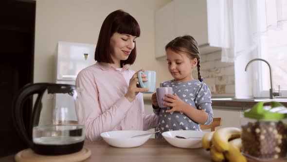 Portrait of a Happy Smiling Family Having Breakfast on a Weekend Morning in a Bright Kitchen