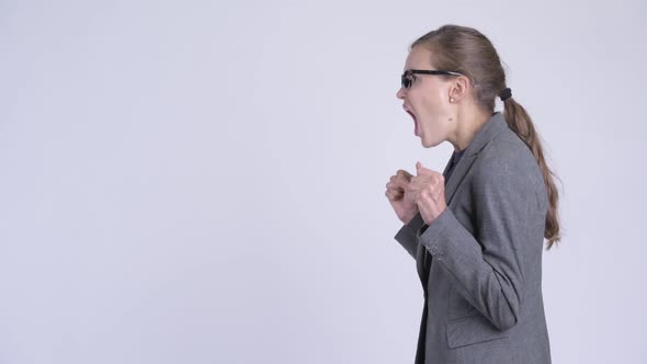 Profile View of Young Angry Businesswoman Shouting and Screaming