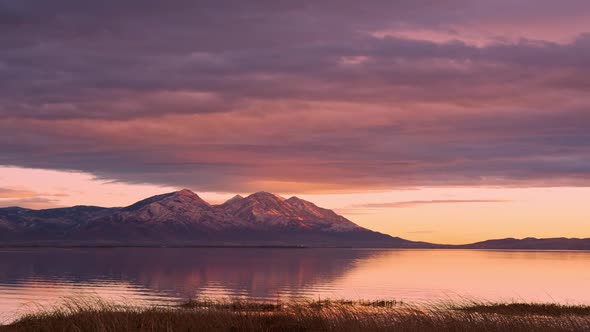 Time lapse of clouds moving over Nebo Mountain reflecting in Utah Lake