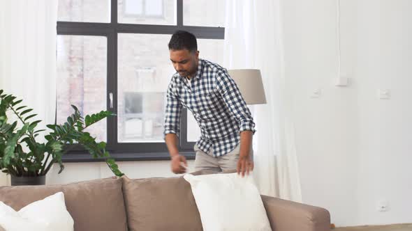 Indian Man Arranging Sofa Cushions at Home 43