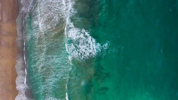 Aerial View of the Mediterranean Coast Waves Reach the Deserted Sandy Beach