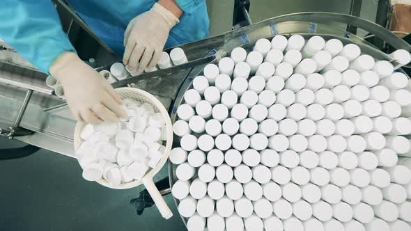 Top View of Pill Bottles Getting Sealed By a Pharmacologist
