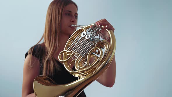 Young Beautiful Plays the French Horn