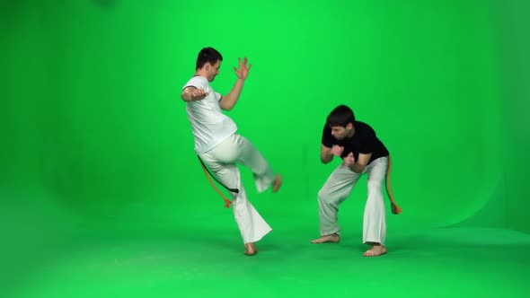 Two Man Are Practicing Capoeira on Chroma Key. Slow Motion.