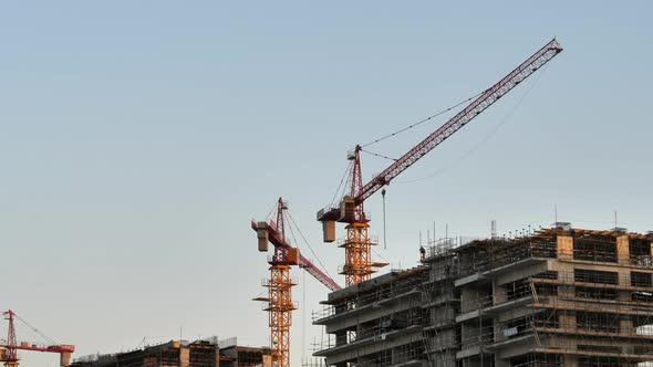 Static shot of cranes working on building construction