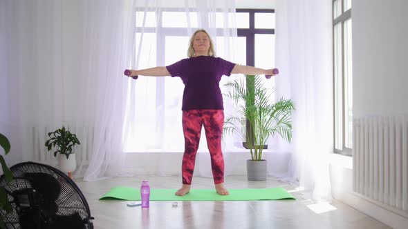 Fitness Training Blonde Overweight Woman Doing Fitness Exercises Standing on Yoga Mat and Training