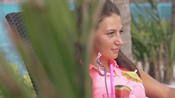 Palm Branches Sway Slowly in Light Wind and Girl Relaxes