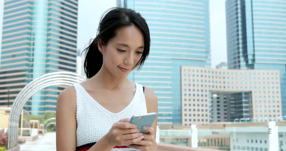 Woman using smart phone in the city