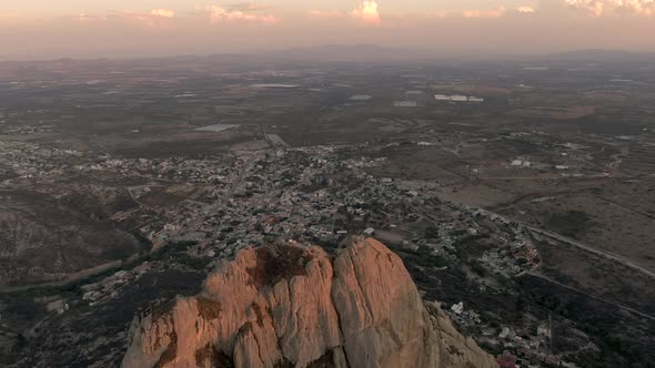 Flying Over Peña de Bernal With Bernal Town During Sunset In Queretaro, Mexico - 13 Wonders of Mexic