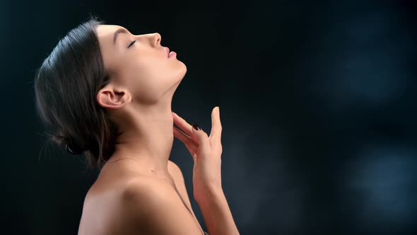 Adorable Fashion Model Touching Chin Smooth Skin Body Care Posing Isolated on Black Gradient Studio