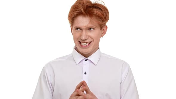 Mad Disheveled Caucasian Ginger Young Man Expressively Standing on White Background and Pointing His